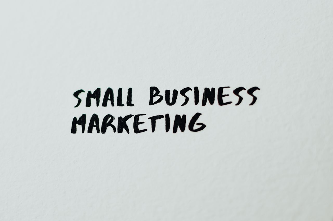 about-us Text Small Business Marketing written on white paper for creative use.